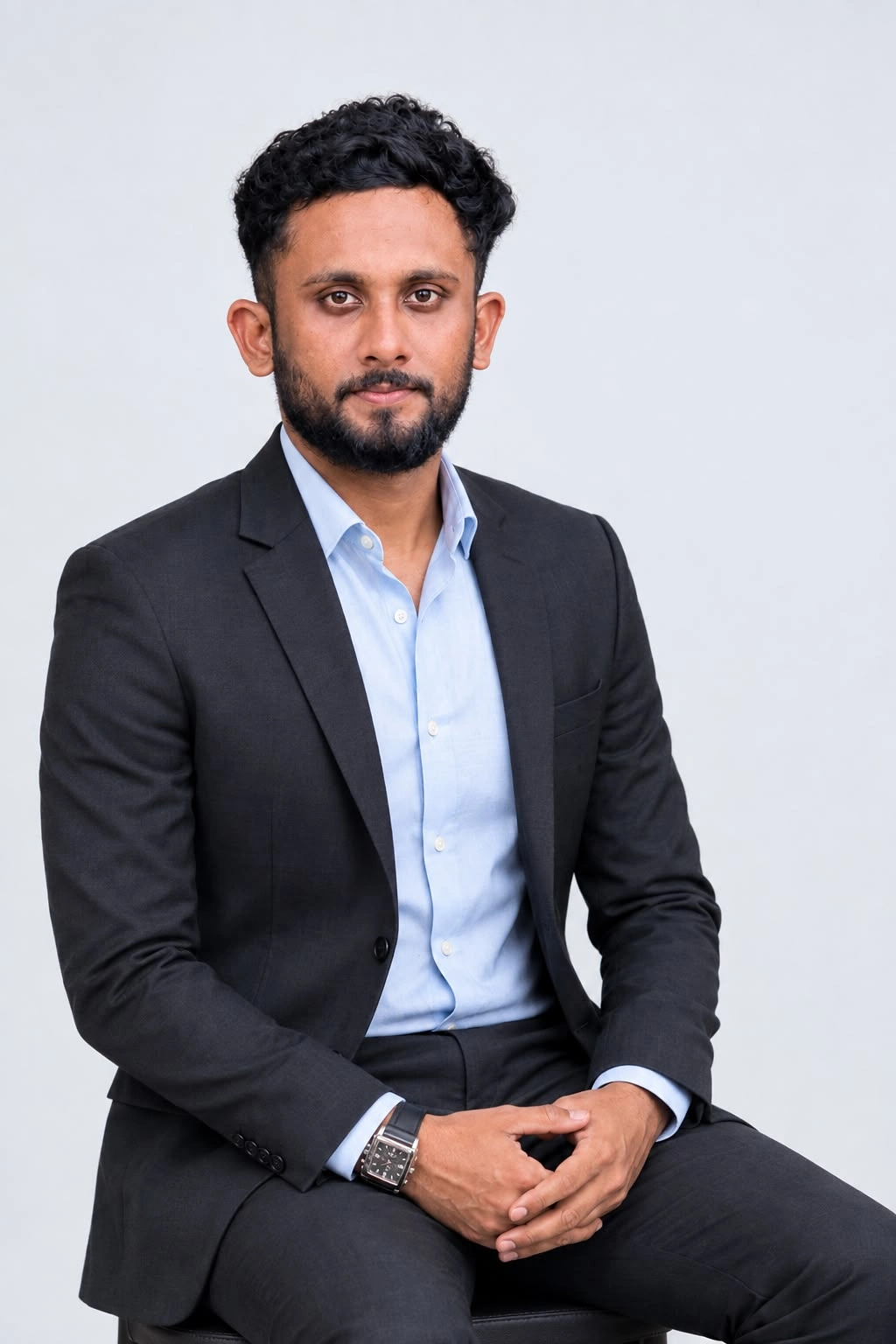 CA Fahad seated in a charcoal suit and light blue shirt